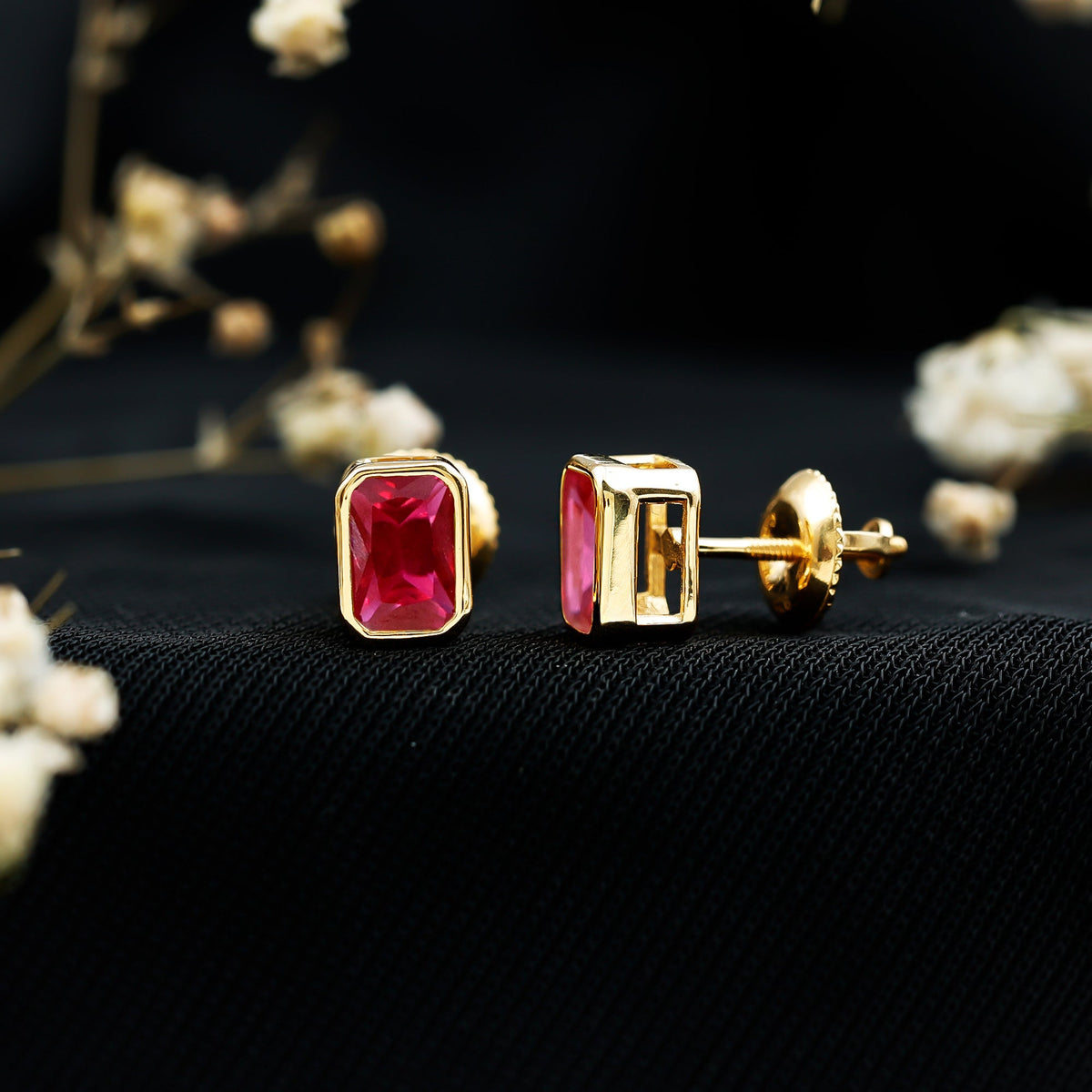 1.5 Carat Emerald Cut Lab Grown Ruby Stud Earrings in Bezel Set
