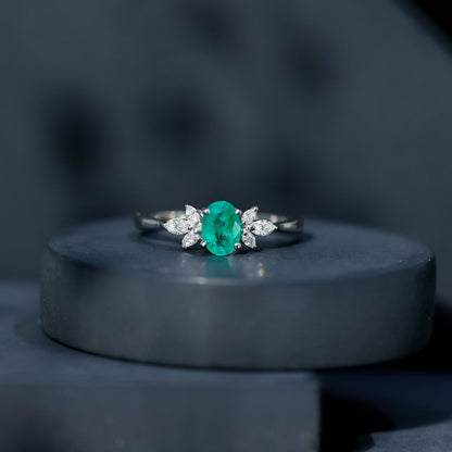 Oval Shaped Emerald Engagement Ring with Marquise Diamond Trio